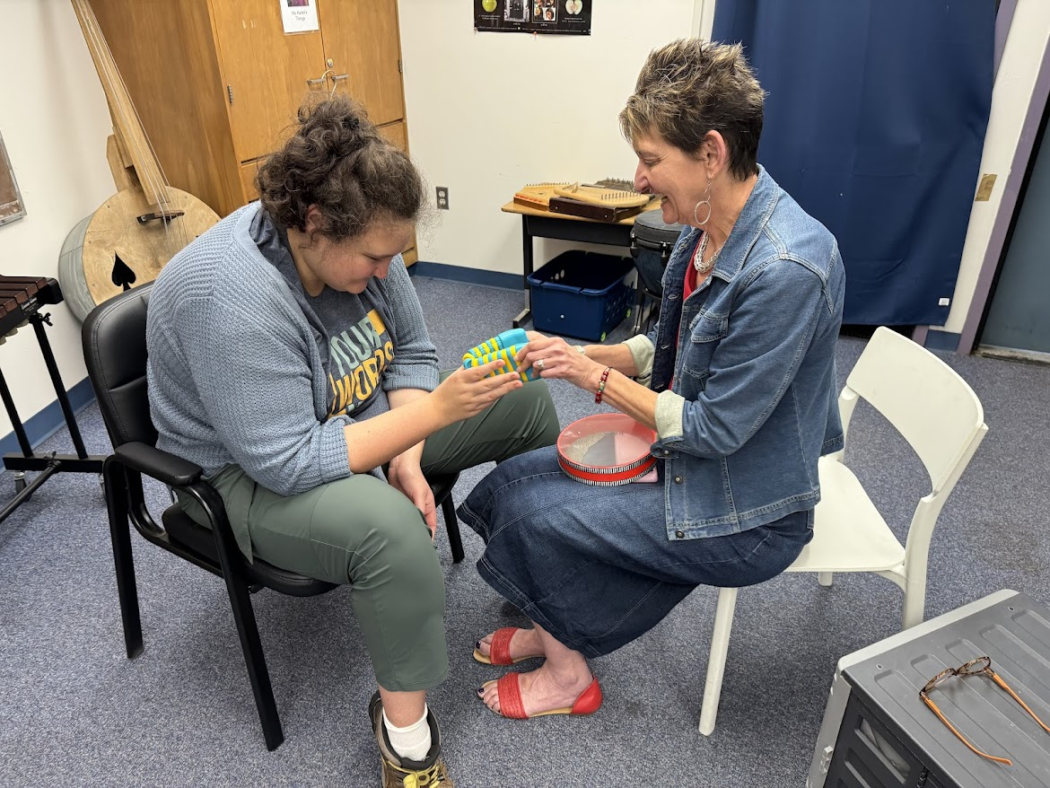Adult and child engaged in art activity at Creekside School