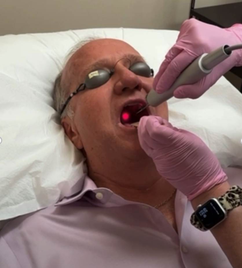 white middle aged man getting nightlase performed on his throat to treat sleep apnea