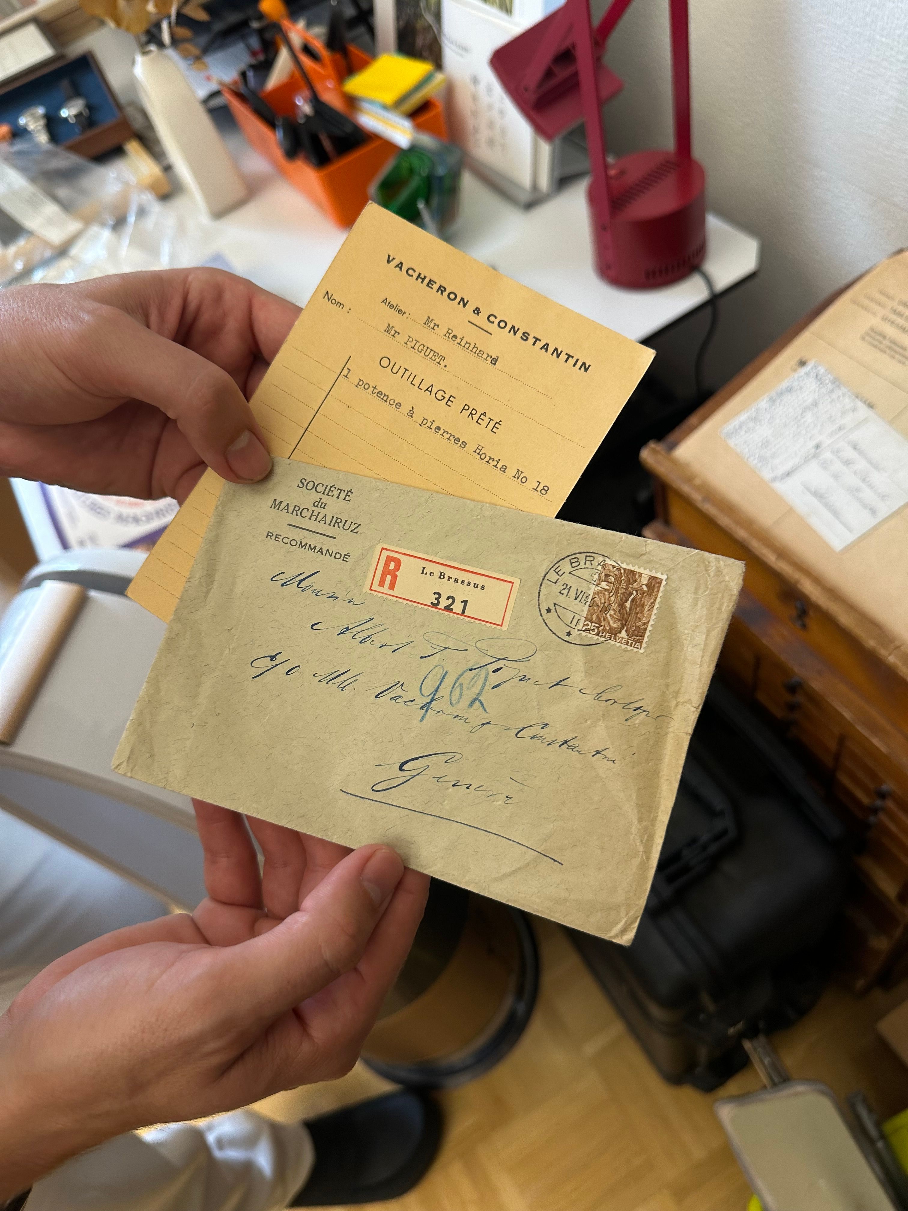 hands holding old letters written to Mr. Piguet
