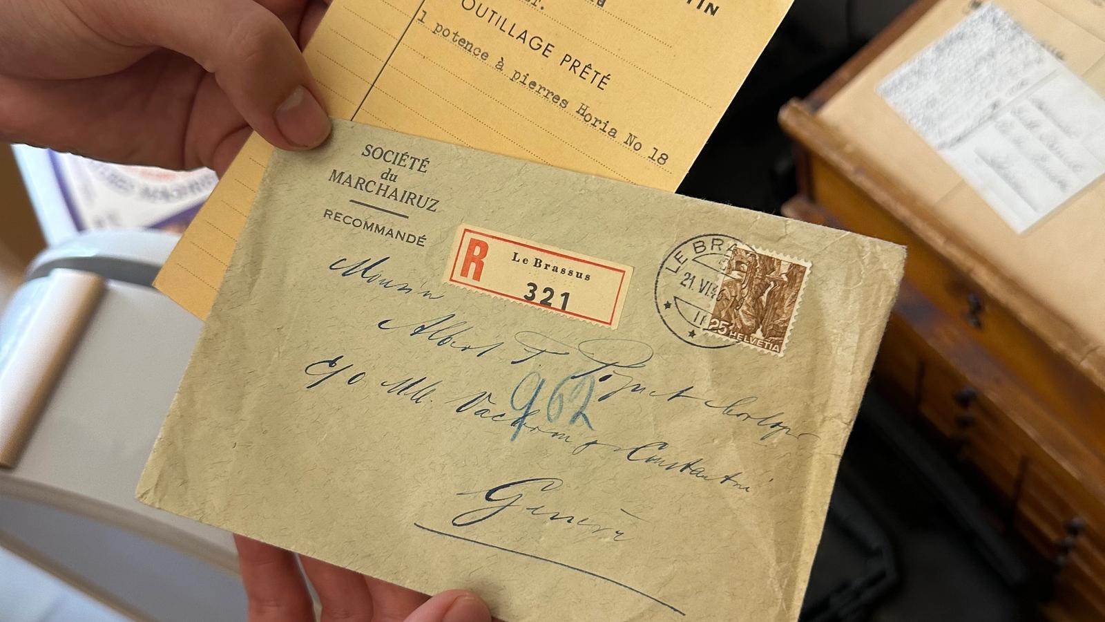 hands holding old letters written to Mr. Piguet