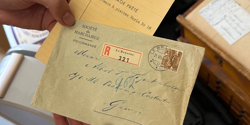 hands holding old letters written to Mr. Piguet
