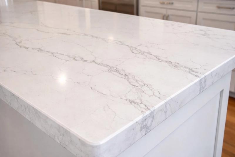 White Calacatta quartz countertop with grey veining on kitchen island in Roseville home remodel by Western Renovations