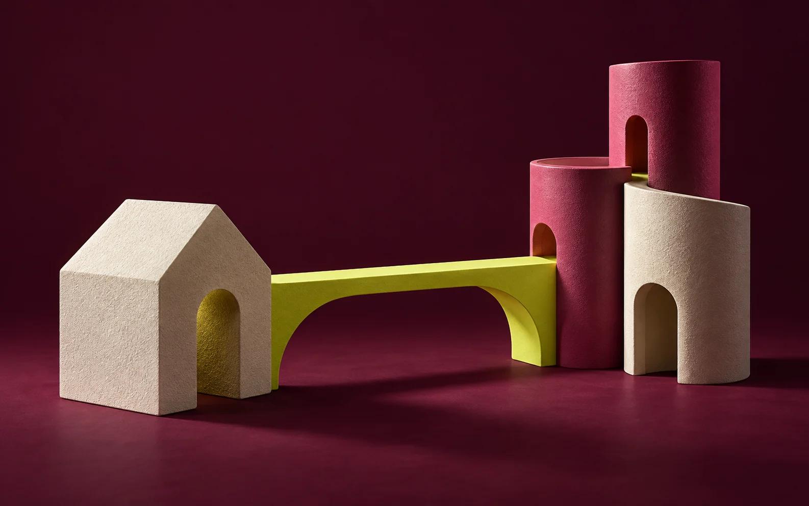 A yellow bridge connects a cream house to a cluster of rose and cream pillars.