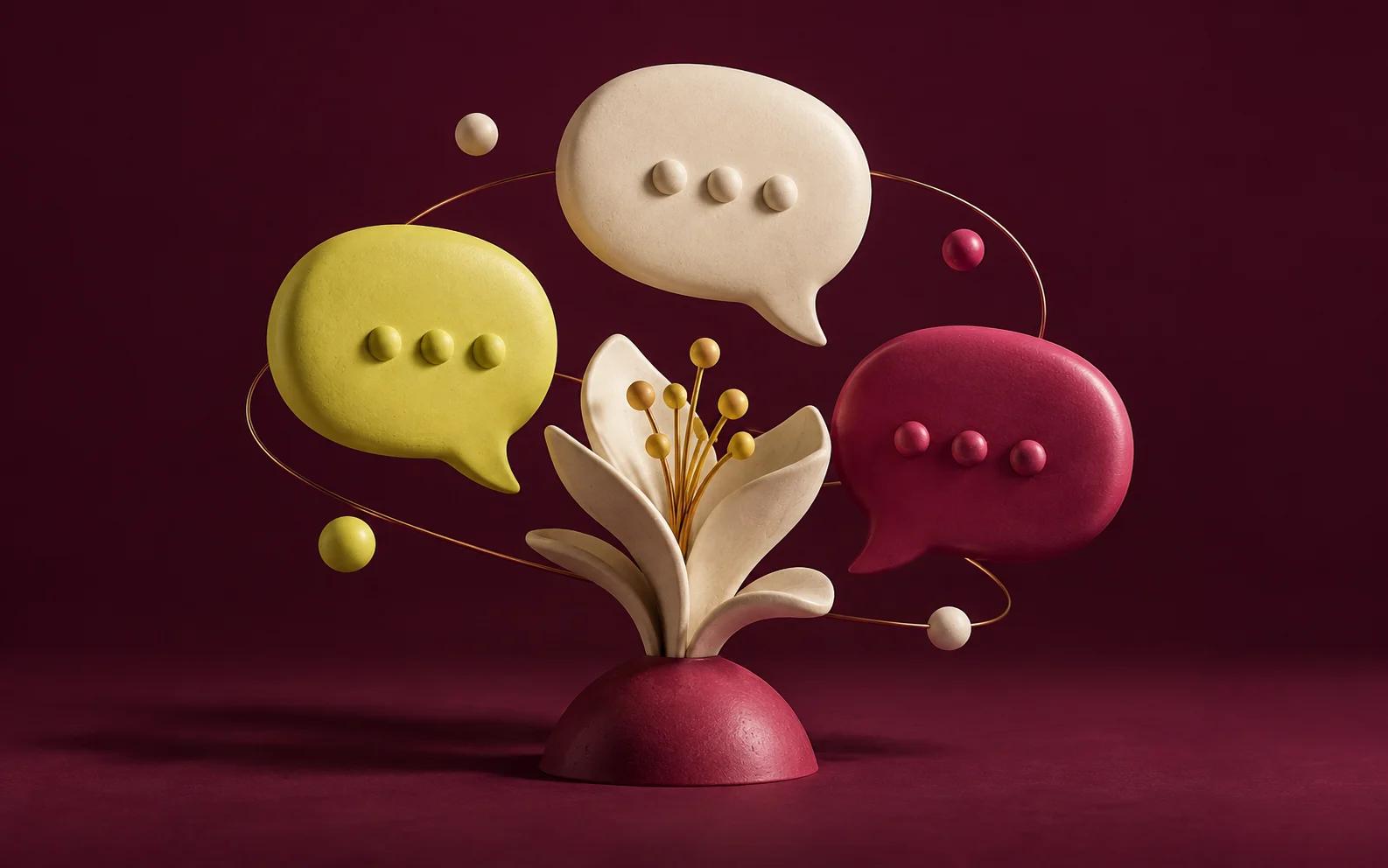 Ceramic speech bubbles in yellow, cream and rose surround a sculptural bloom.