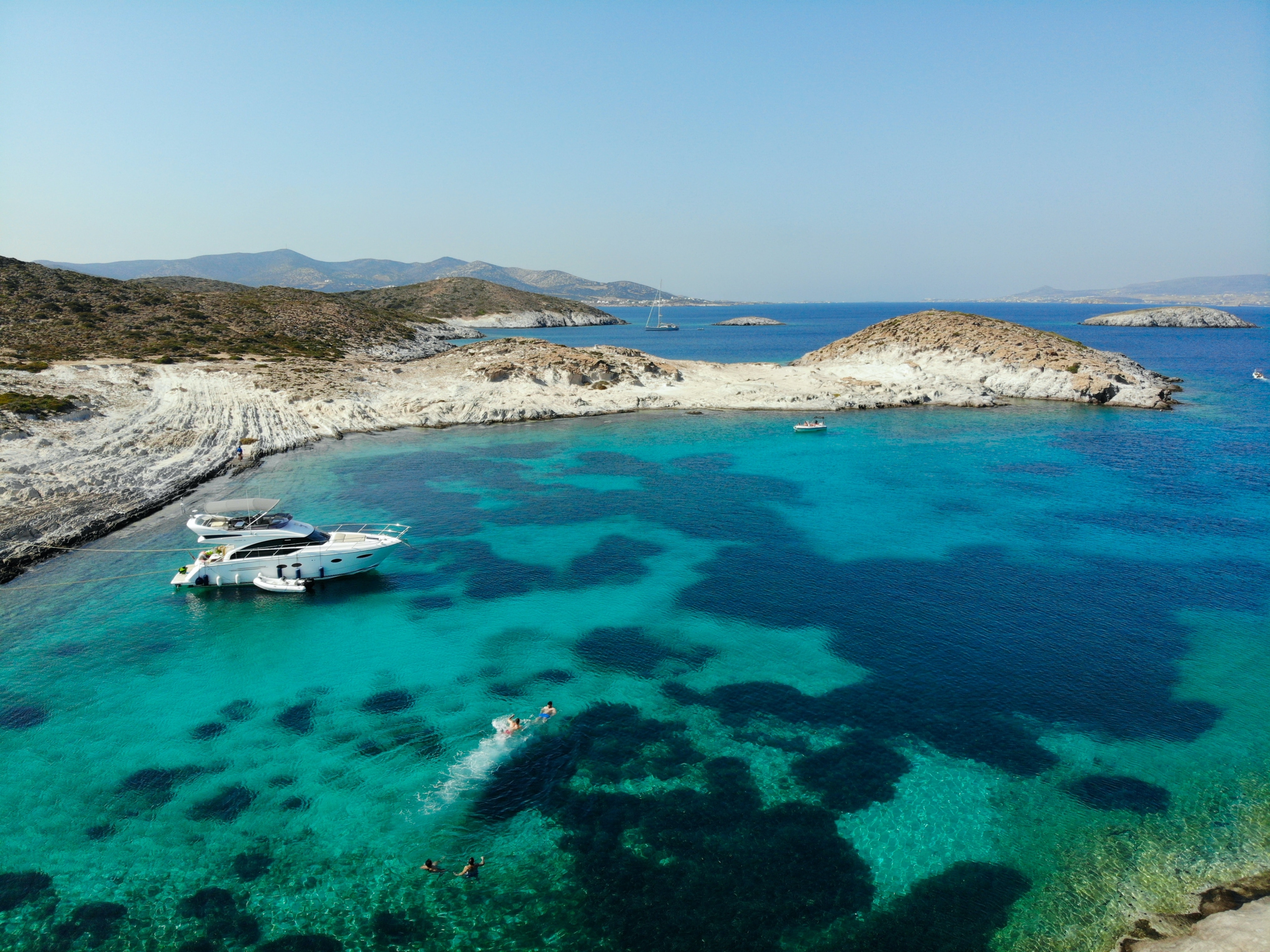 Anchored yacht floating on a crystal-clear water in a bay