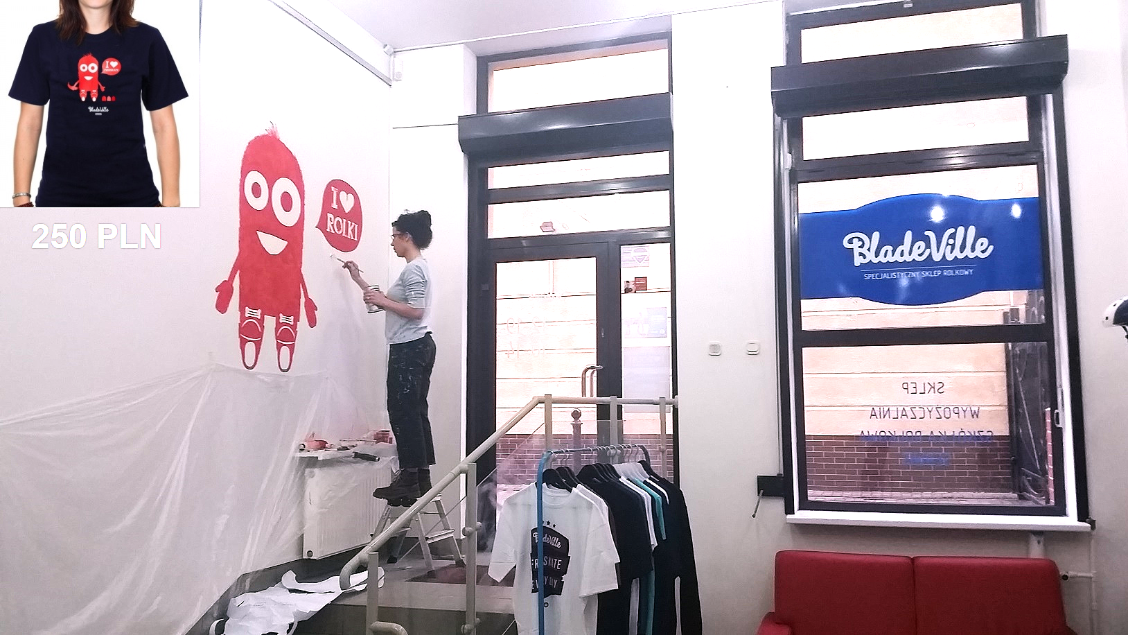 An artist is painting a mural a logo on the wall in a bladeroller store, in Warsaw.