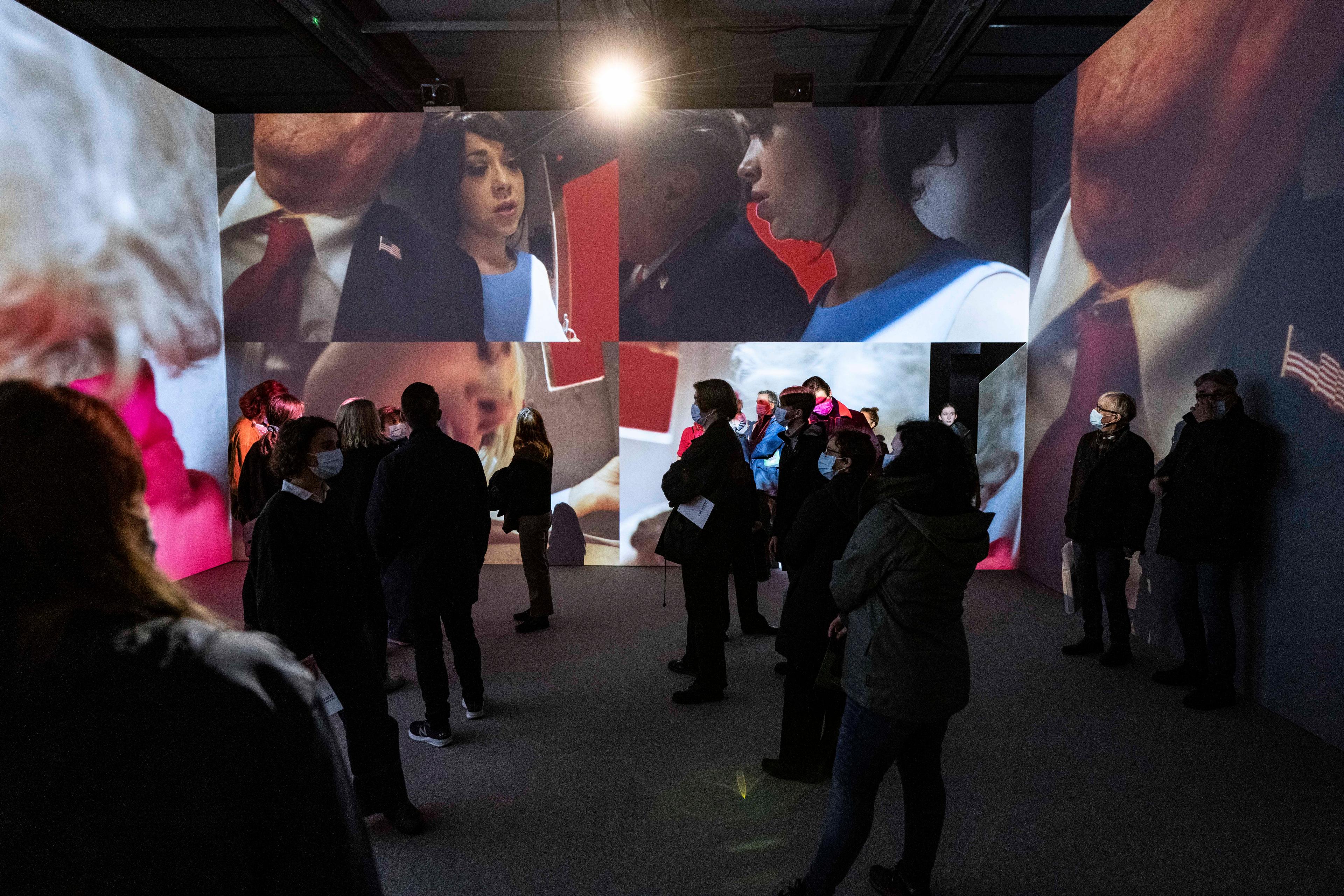 A group of people inside a video installation.