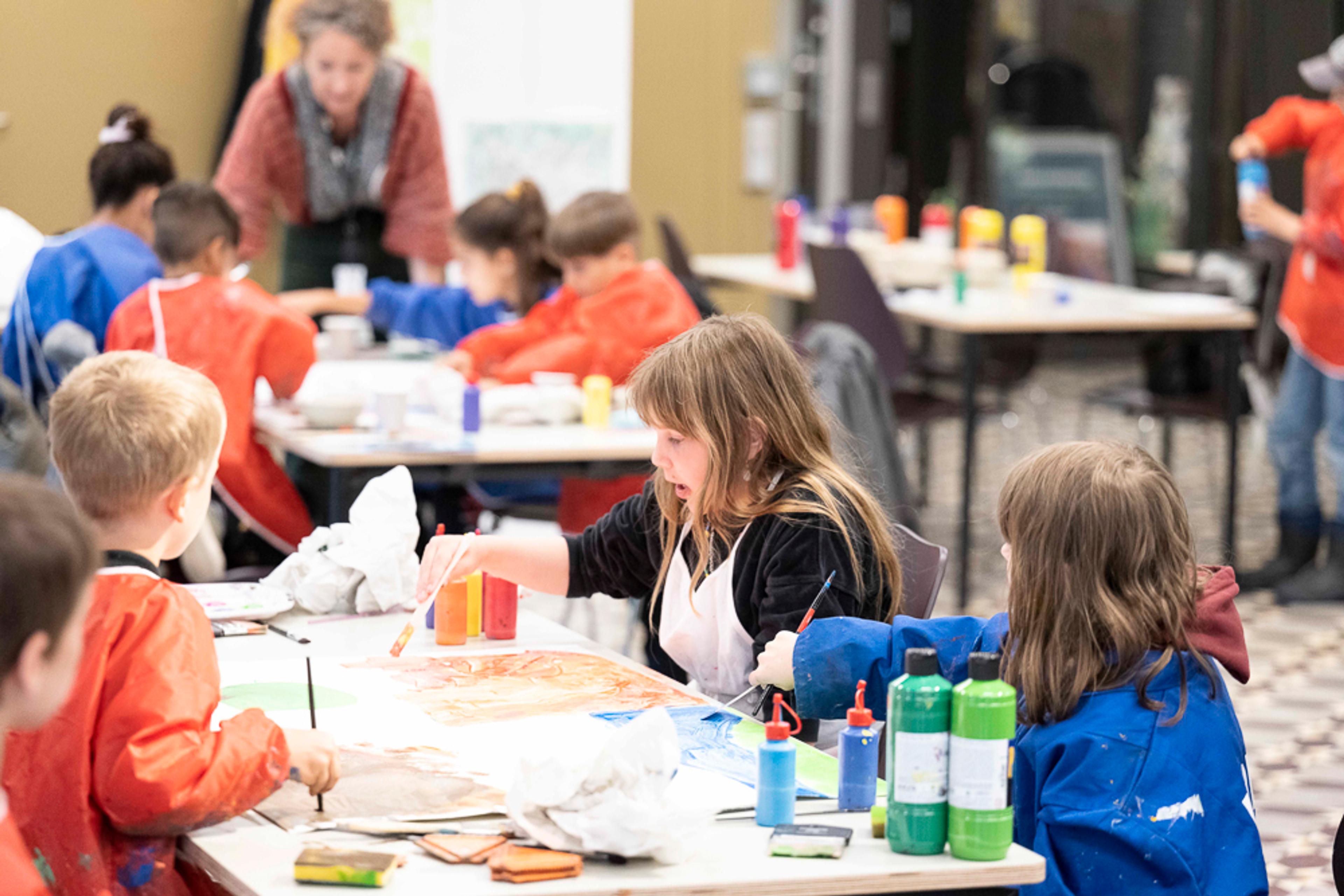 Image of children painting as part of the museum family workshop. 