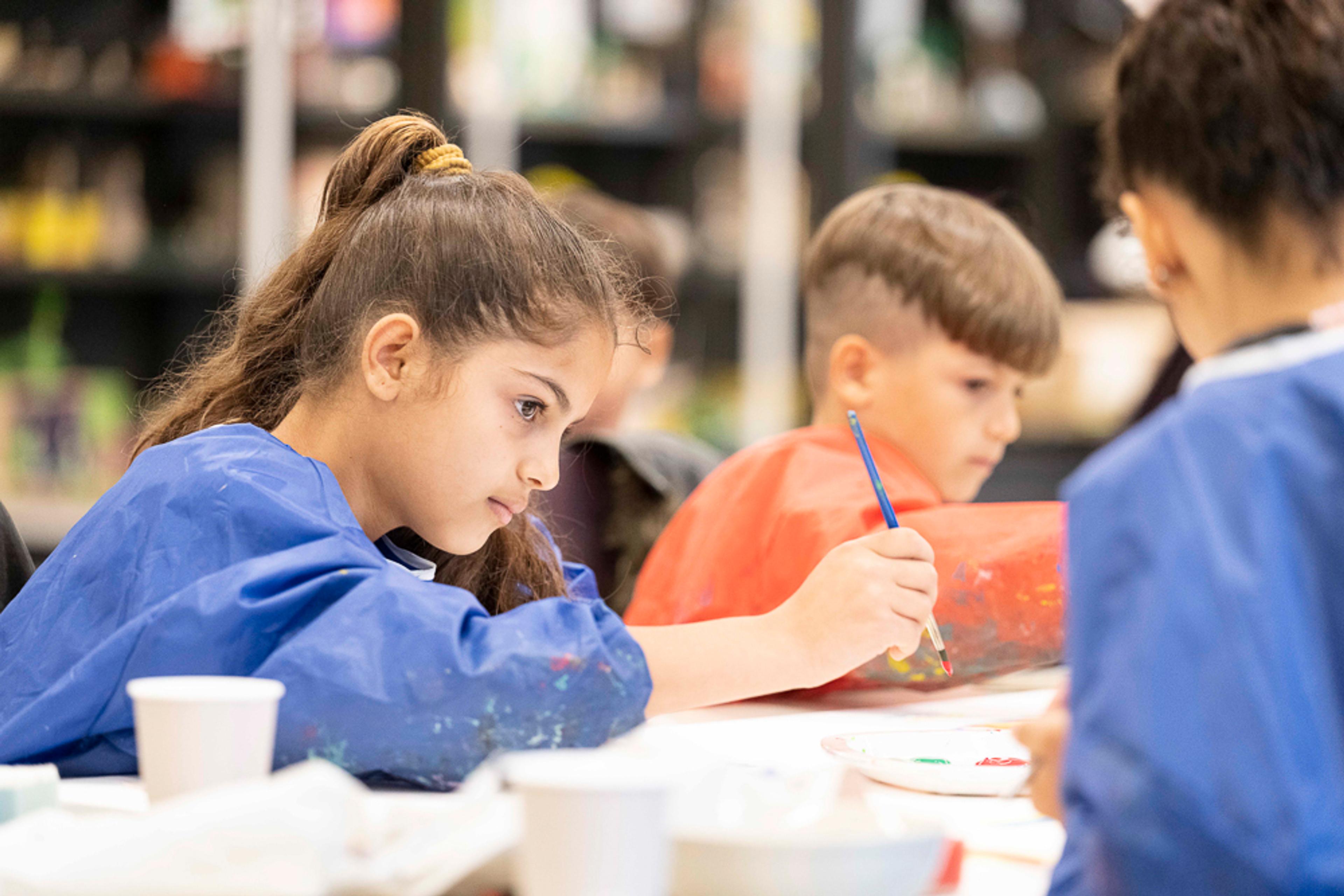 Image of children painting as part of the museum family workshop. 