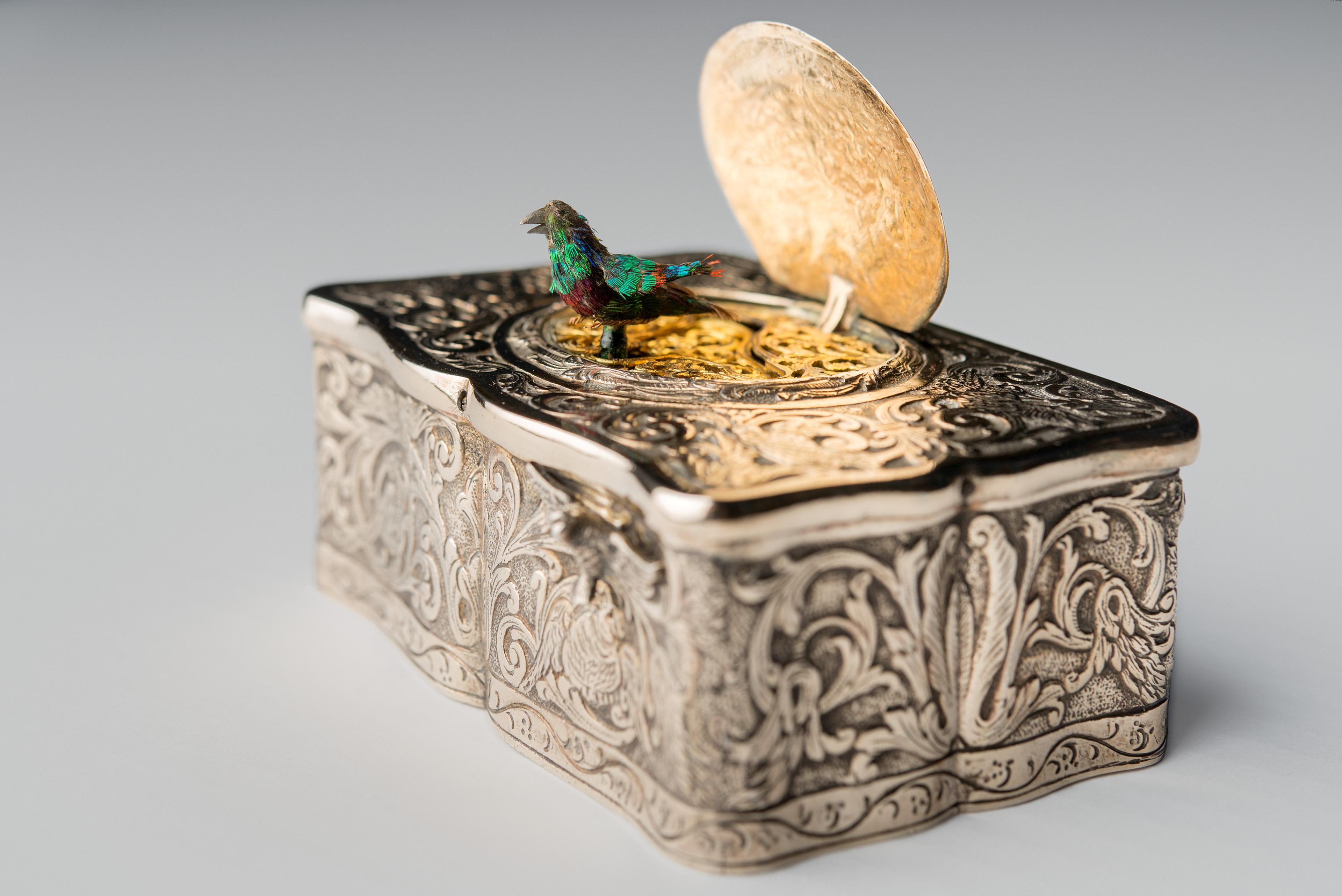 En spilledåse i delvis forgylt sølv, med en liten fugl på lokket