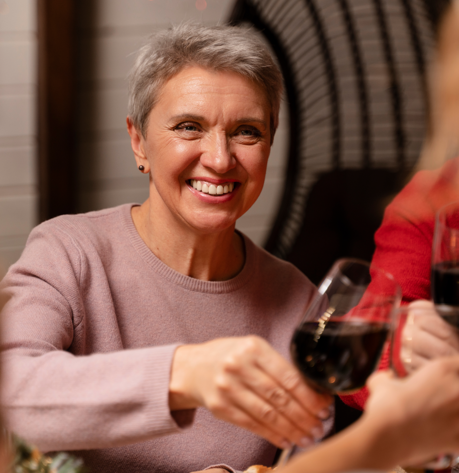 Woman smiling enjoying a glass of red wine