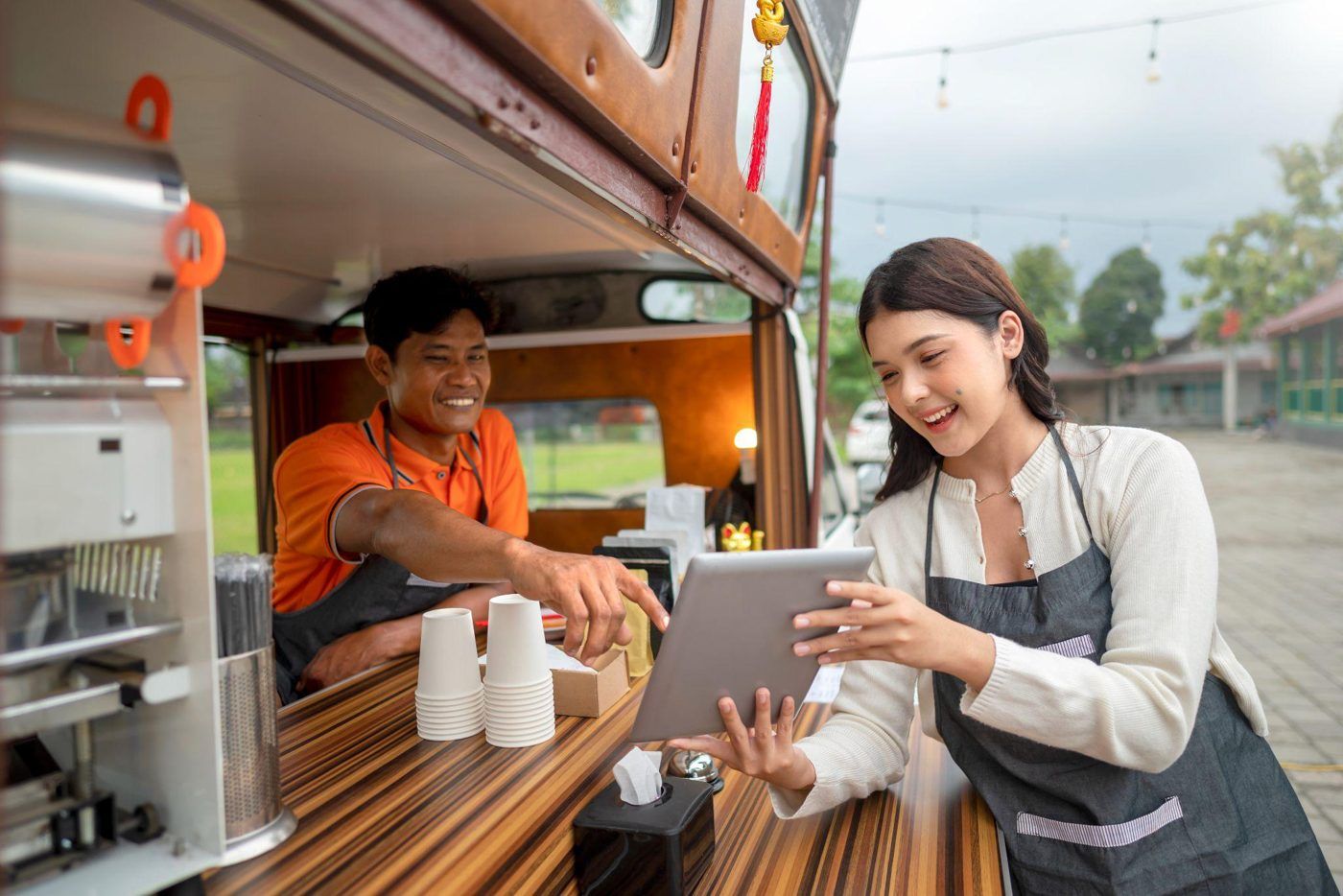 People gathered outdoors beside a food truck