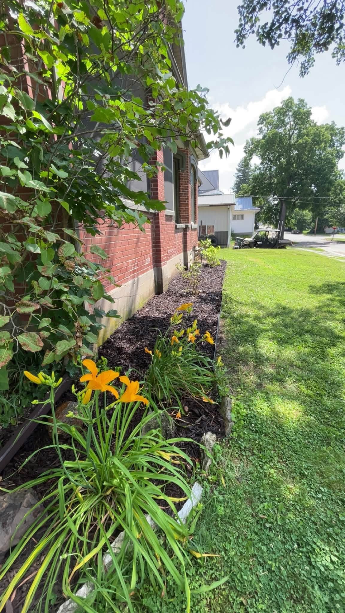 Finished flower bed with fresh dark mulch