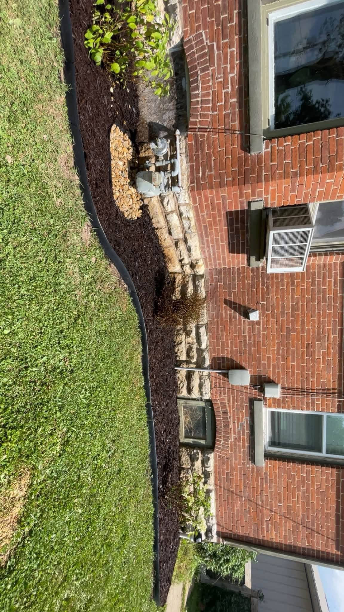 Curved mulched bed and stone border