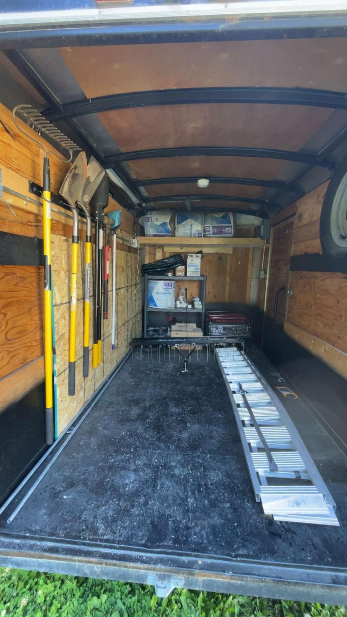 Work trailer organized with landscaping tools