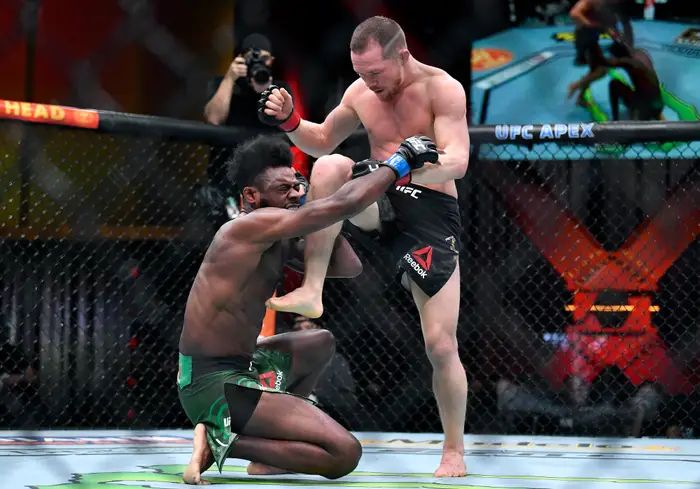 Petr Yan hits Aljamain Sterling with an illegal knee late in the fourth round