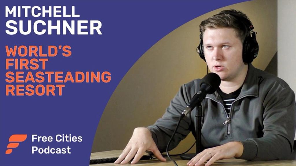 Free Cities Podcast thumbnail of Mitchell Suchner at a microphone, titled World's First Seasteading Resort