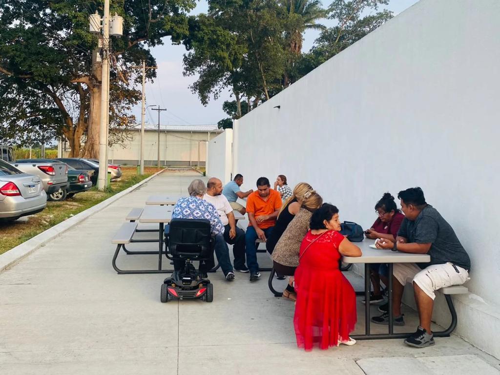 Residents gathered at picnic tables for a Father's Day get-together in Ciudad Morazán, June 2023