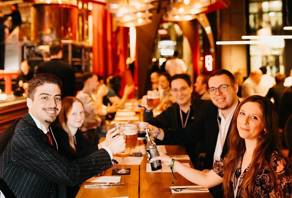Liberty in Our Lifetime attendees raising beer glasses together at a brewery restaurant in Prague