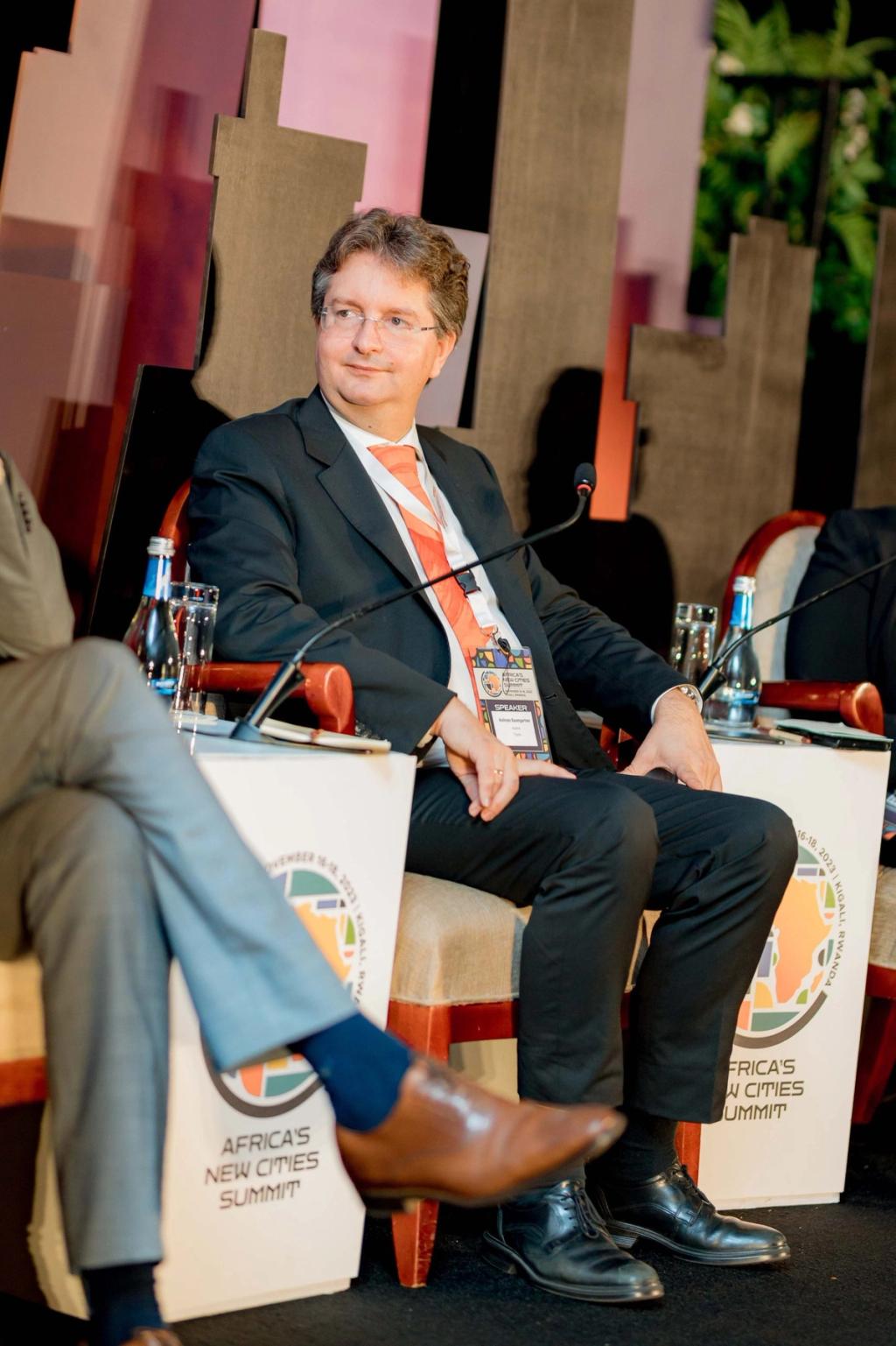 Tipolis CSO Andreas Baumgartner seated on a panel at Africa's New Cities Summit in Kigali