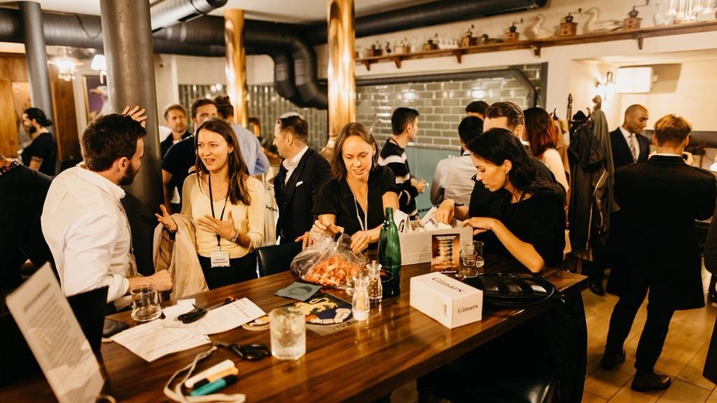 Attendees collecting conference passes at the welcome drinks at Fuze Restaurant, Liberty in Our Lifetime in Prague