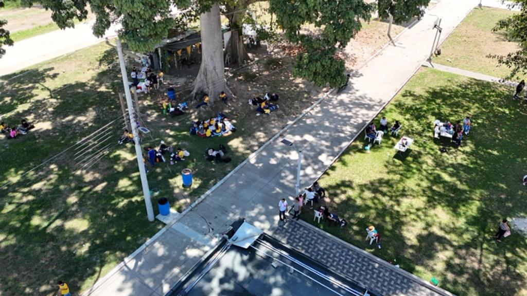 Aerial view of a community activity on the shaded lawns of Ciudad Morazán, Honduras