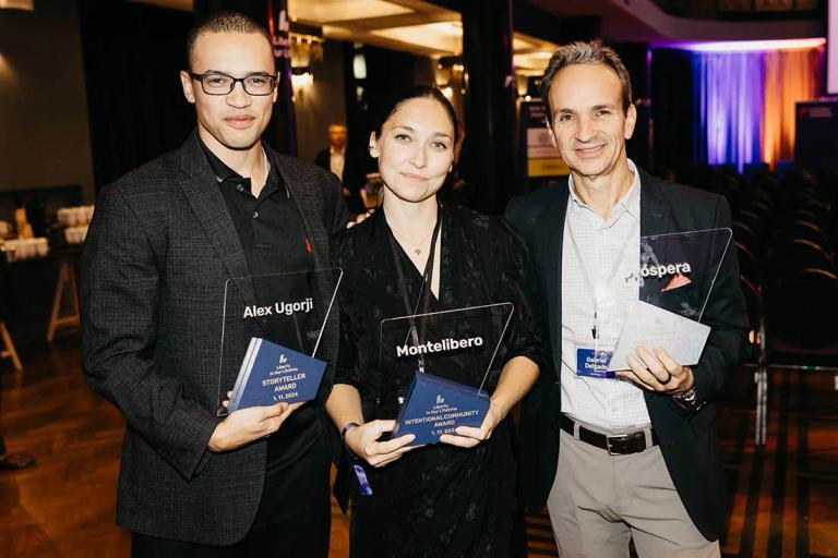 Alex Ugorji, Tatiana Butanka and Gabriel Delgado-Ayau holding their awards on stage at Liberty in Our Lifetime 2024 in Prague