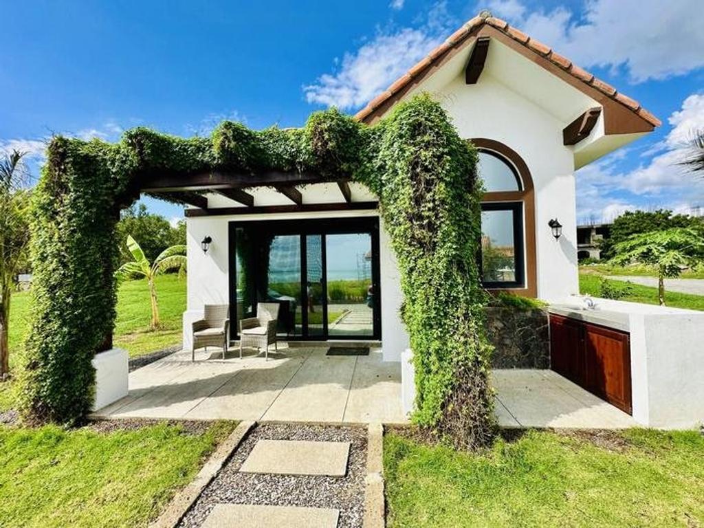 White villa with ivy-covered pergola at Veritas Villages' Playa Pacifica community in Nicaragua