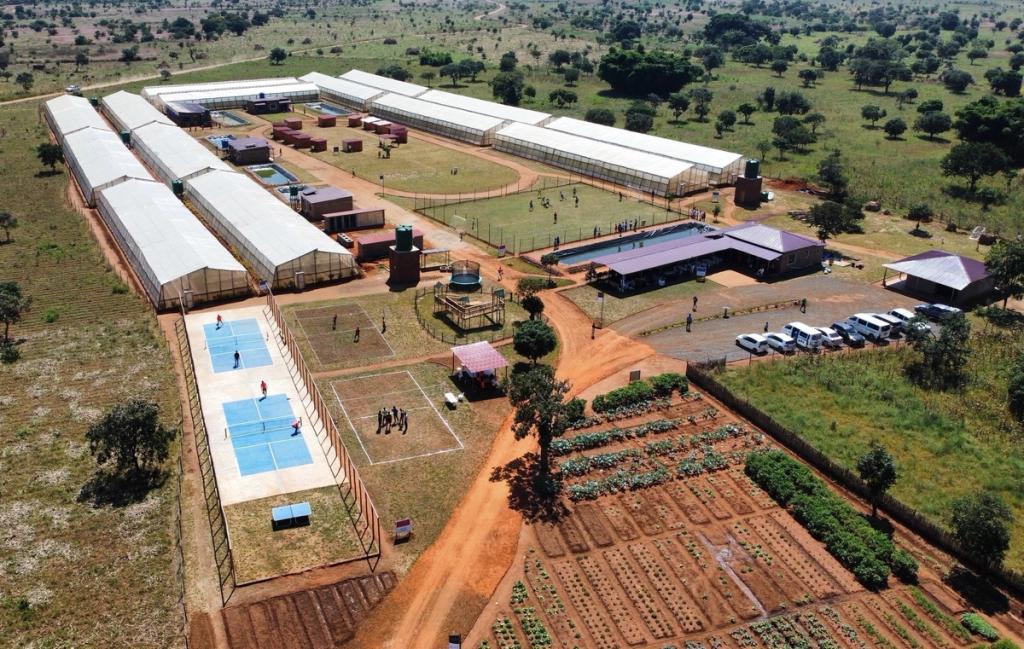 Aerial view of Small Farm Cities Africa in Malawi with greenhouses, vegetable plots, sports courts and buildings