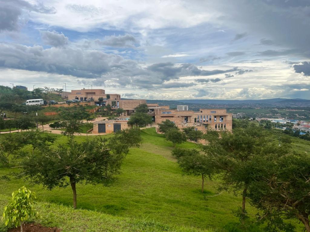 Sandstone campus buildings on a green hillside at Kigali Innovation City, Rwanda