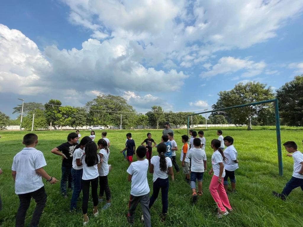 Children from a nearby school playing on the football field inside Ciudad Morazán, Honduras