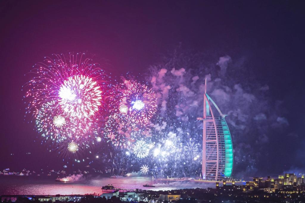 New Year's Eve fireworks lighting up the sky beside the Burj Al Arab in Dubai