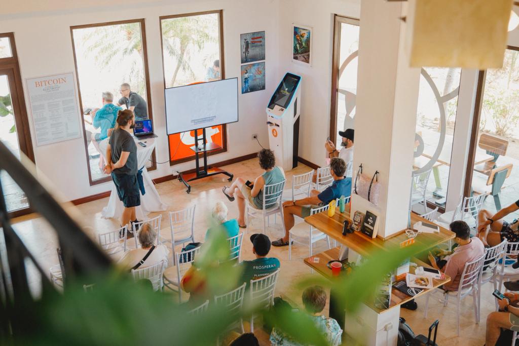 Speaker presenting to a seated audience at Amity Age, the Bitcoin Education Center in Próspera
