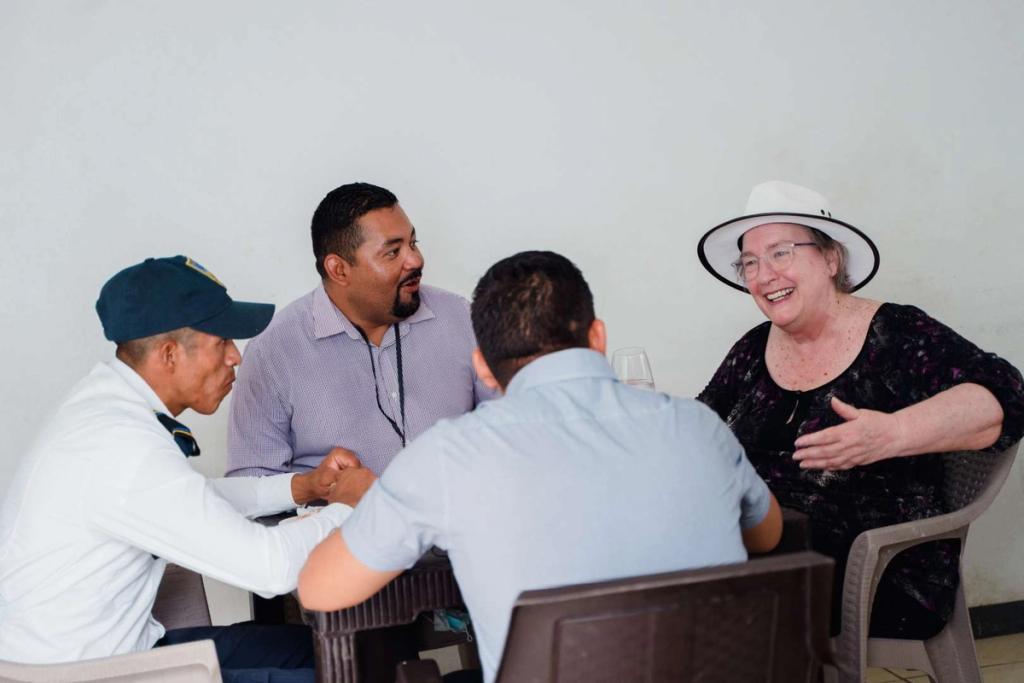 Author Joyce Brand having breakfast with members of Ciudad Morazán's security team