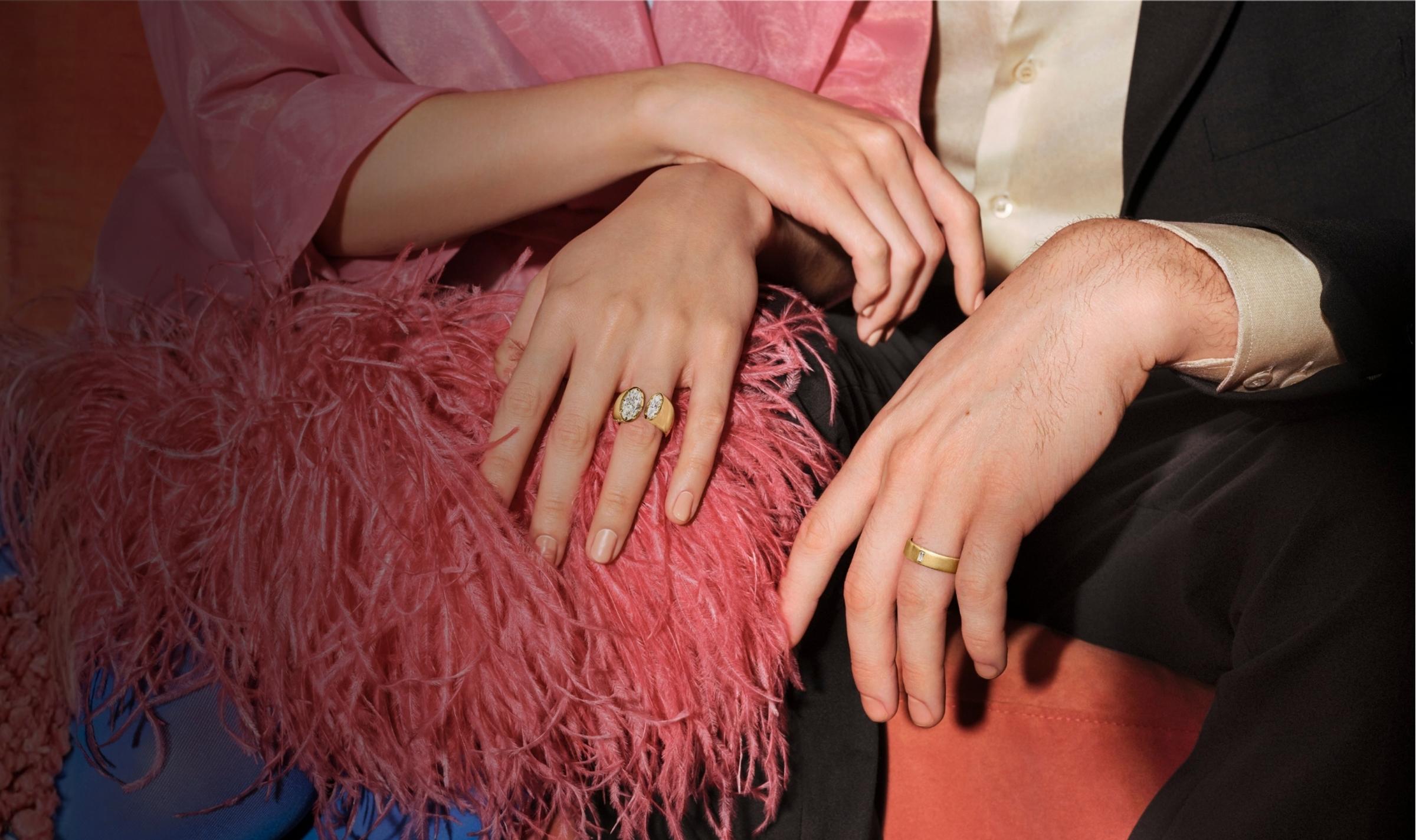 couple wearing engagement ring and wedding band