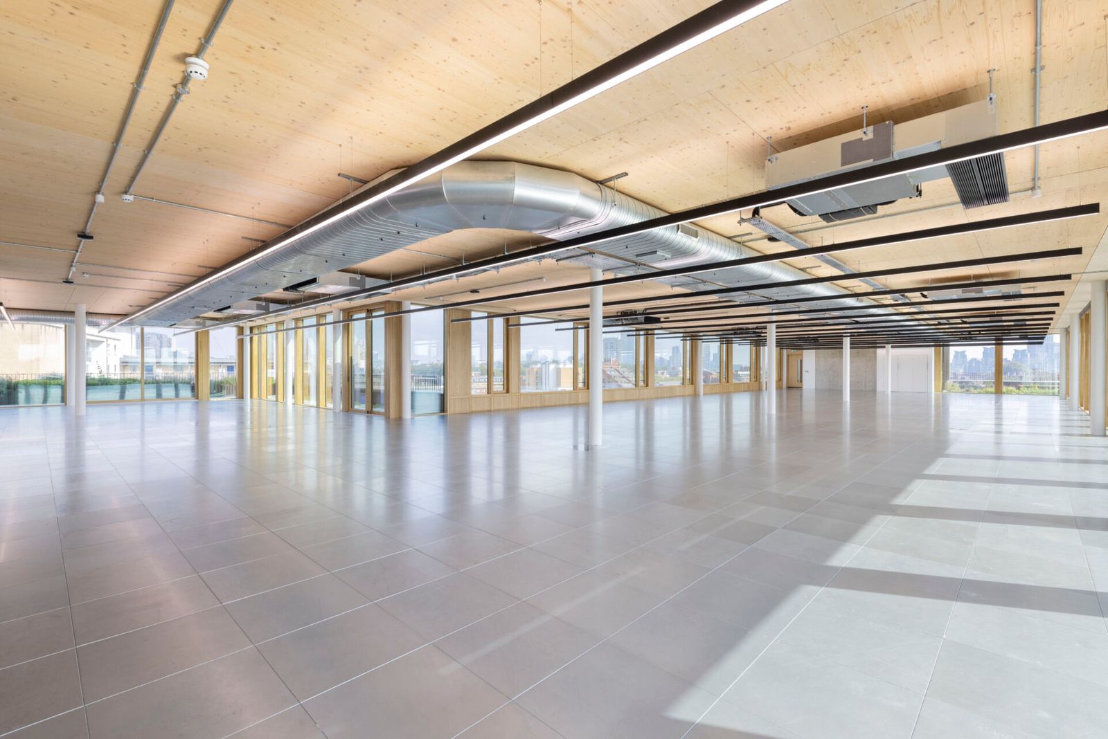 Open plan floorplate at 11 Belgrave Road with exposed timber ceiling and spiral ductwork