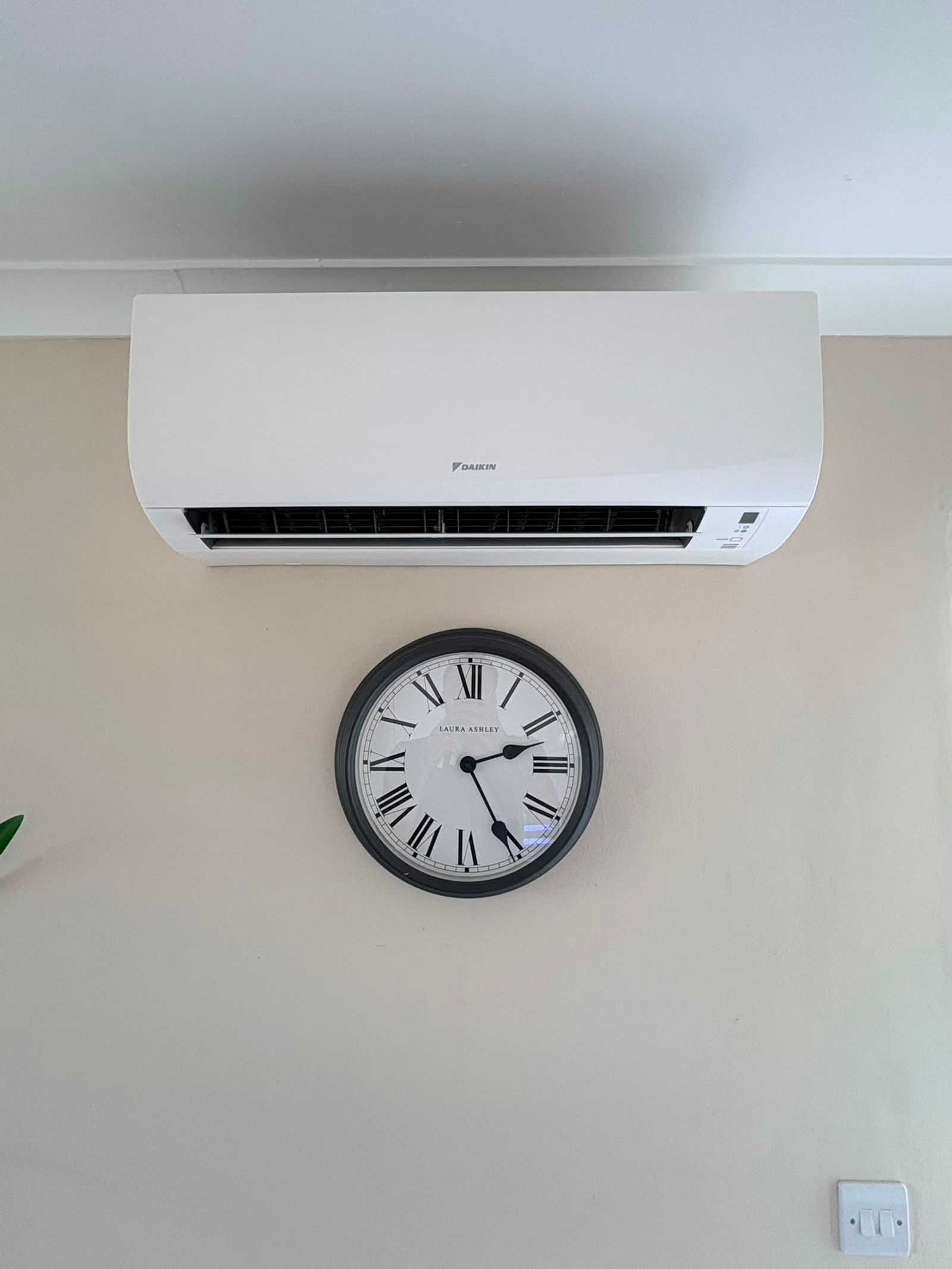 Daikin wall mounted indoor unit installed in a domestic room with concealed pipework
