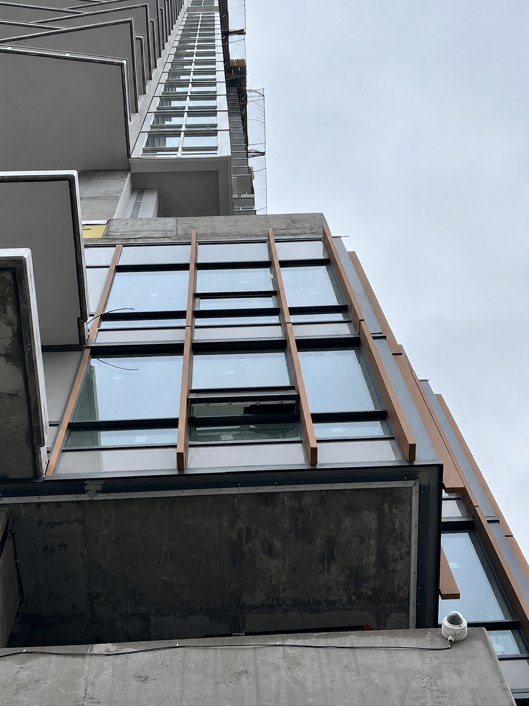 Bronze wood-grain vertical fins on a building exterior façade