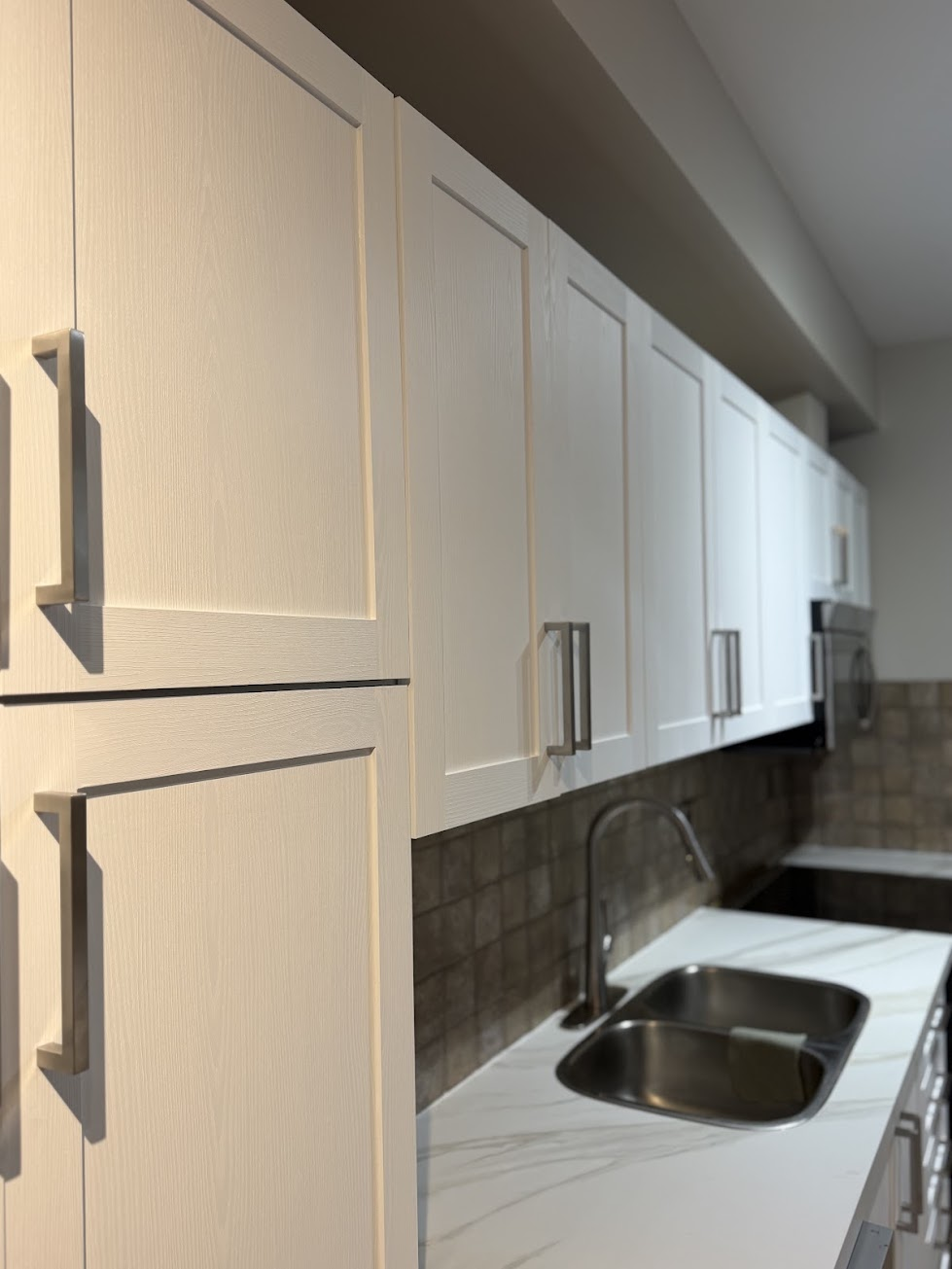 Close-up of shaker-style vinyl-wrapped cabinet doors