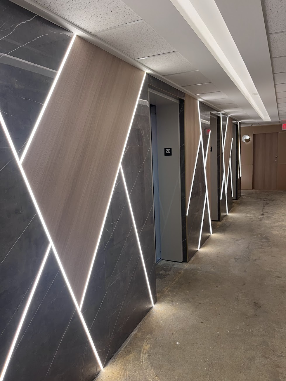 Marble and woodgrain feature wall with linear lighting