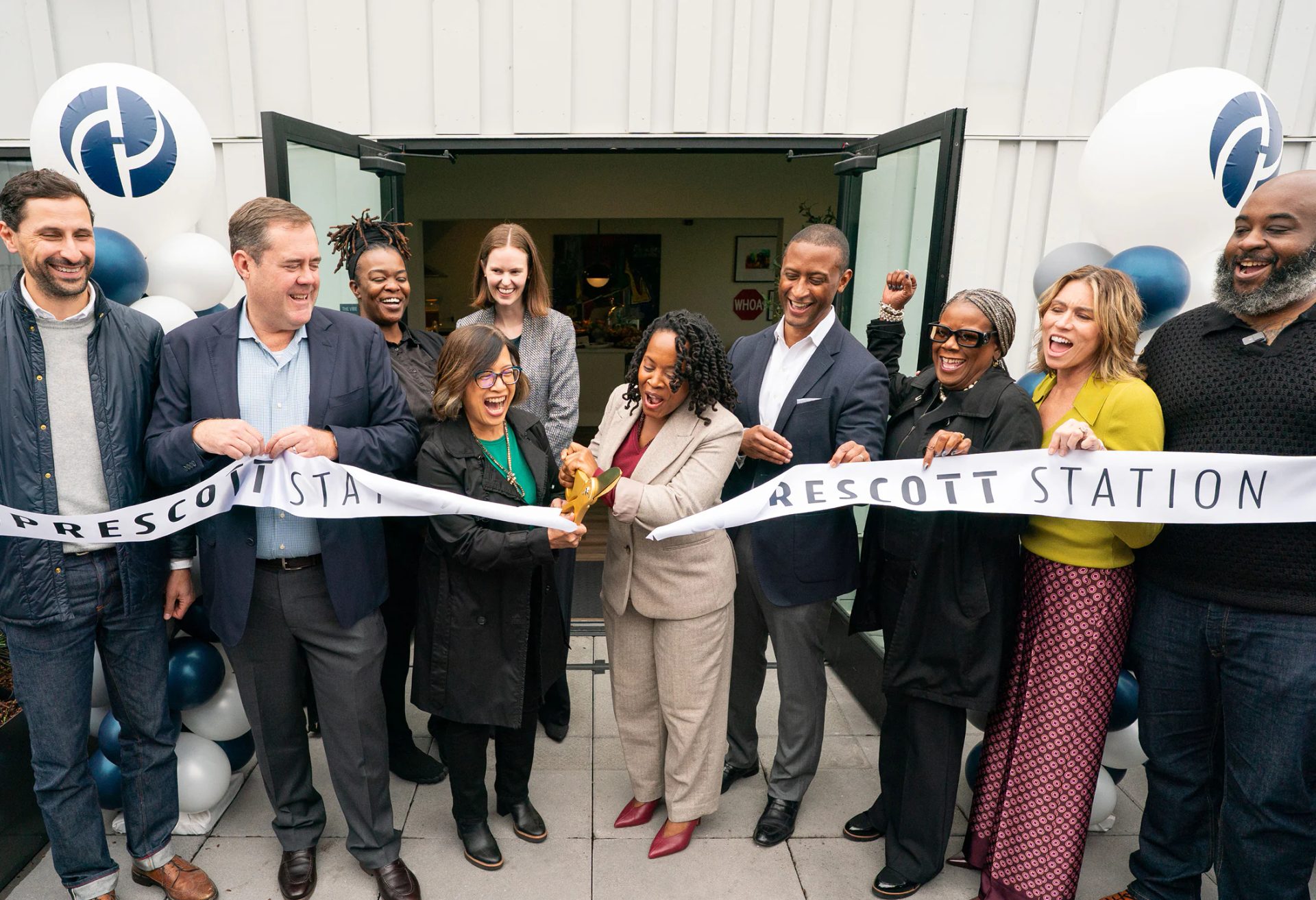 Ribbon cutting ceremony with guests outside Prescott Station