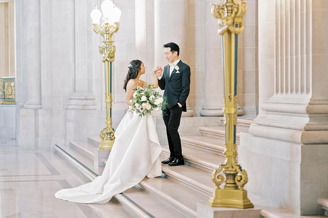 Couple posing inside San Francisco City Hall