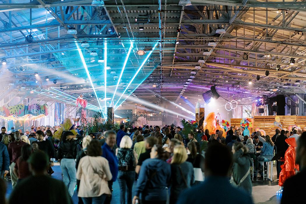 Corporate event crowd gathered under colorful stage lights