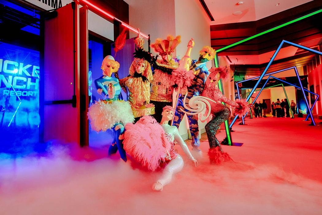 Colorful costumed characters and performers at an event entrance