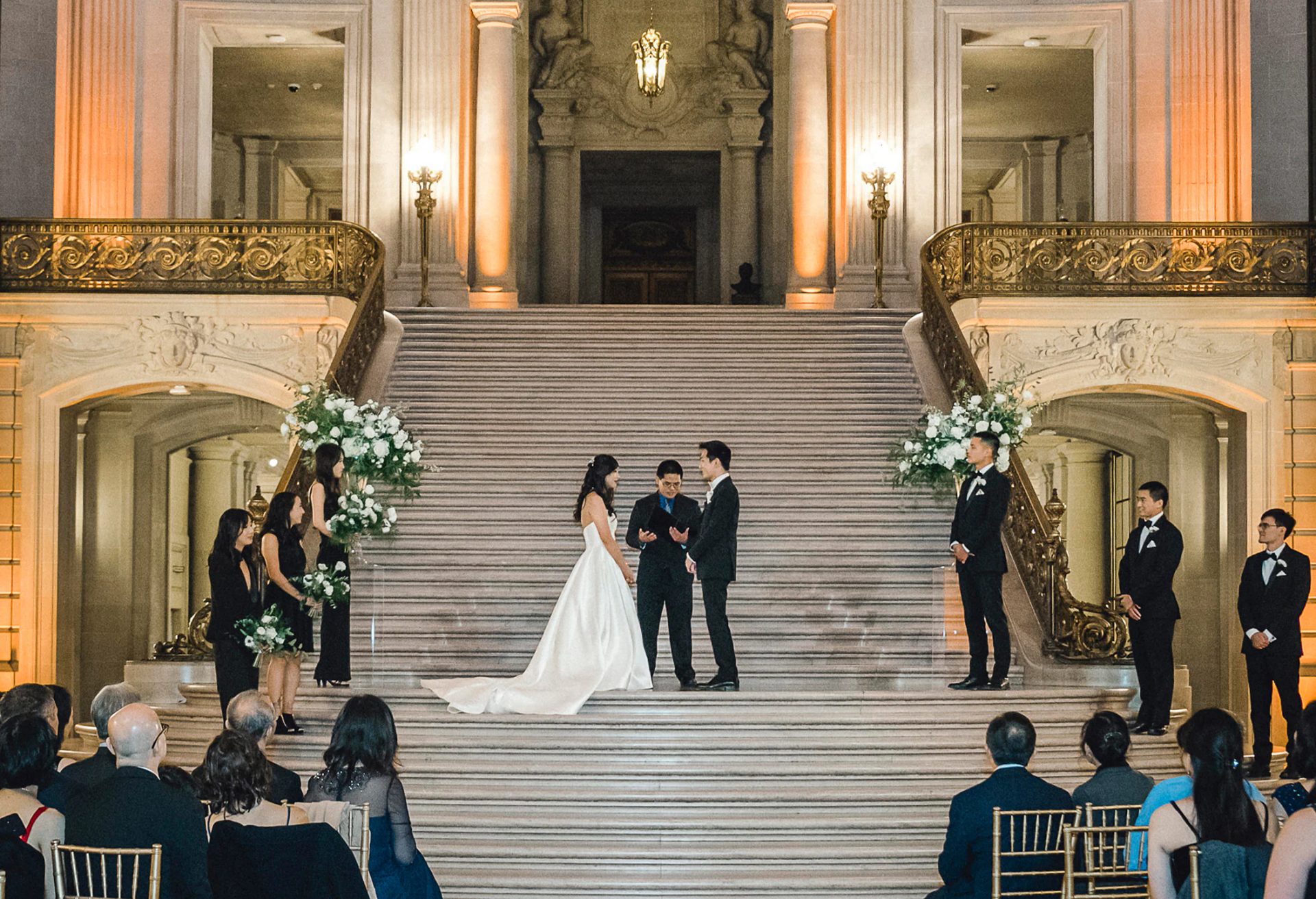 Couple standing on the San Francisco City Hall staircase