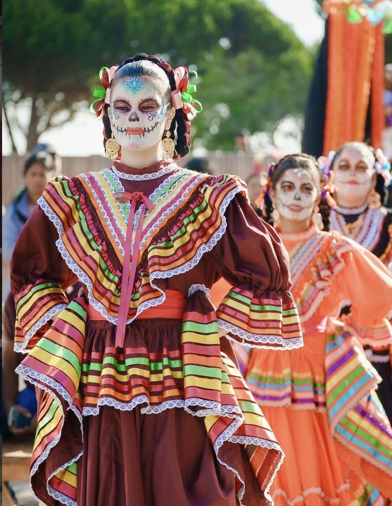 Day of the Dead dancers in colorful costumes