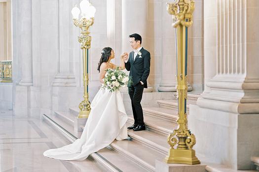 Couple posing inside San Francisco City Hall