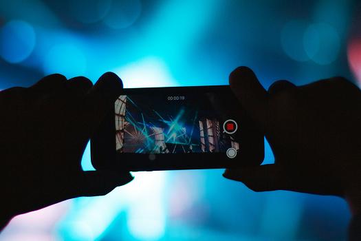 Guest recording a live event performance on a phone