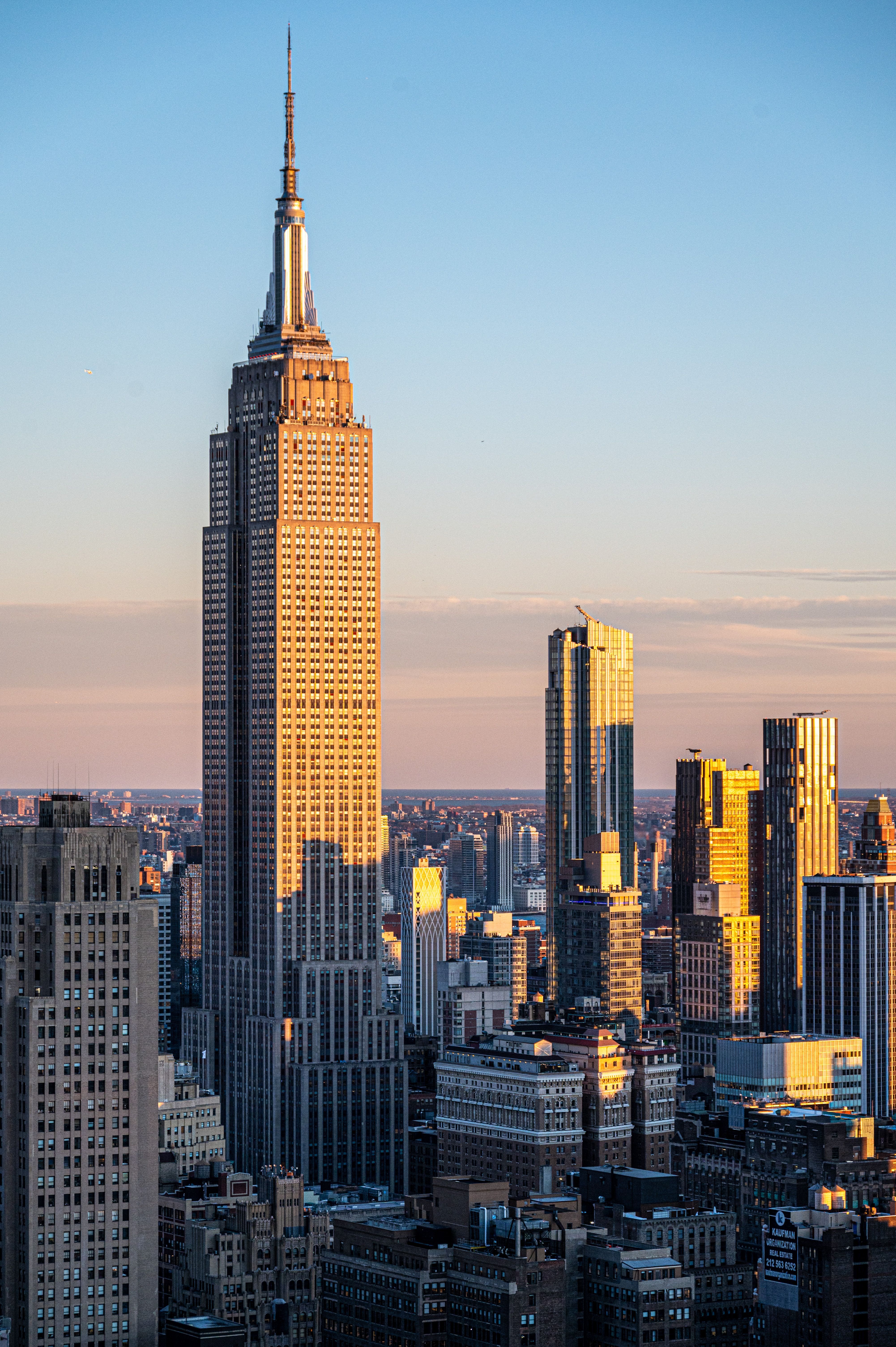 The Empire State Building at sunset, surrounded by Manhattan skyscrapers in New York City