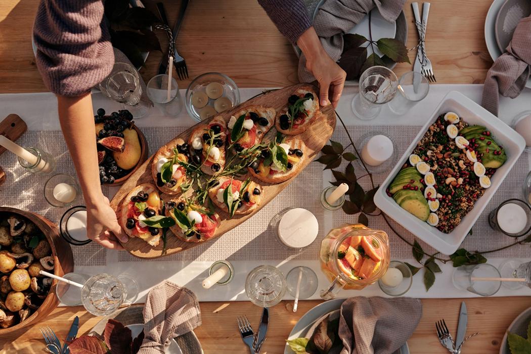 Shared appetizer platters and salads on an outdoor table
